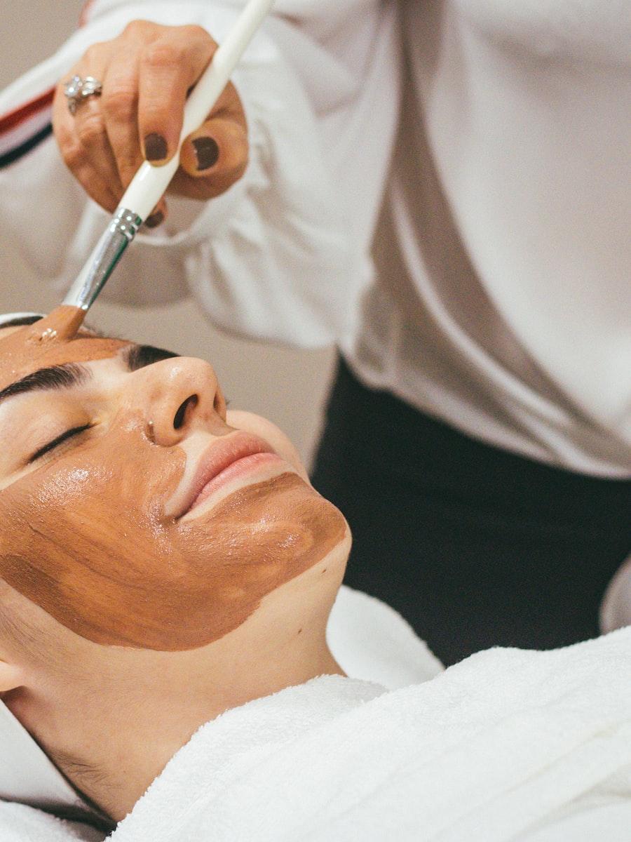 Esthetician performing a facial treatment in a calm med spa room